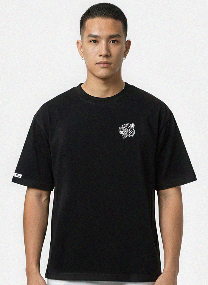 Person wearing a black t-shirt with a logo on a white background